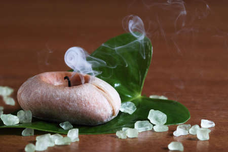 Spa setting with smoking candleの写真素材