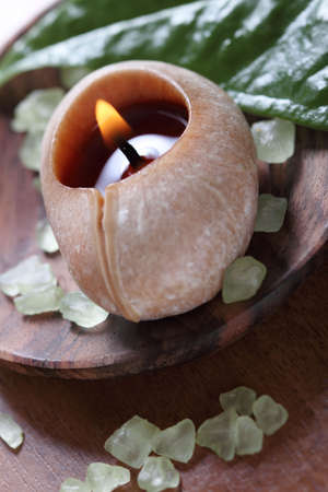 Spa setting with burning candle on the wooden backgroundの写真素材