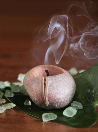 Spa setting with smoking candle and saltの写真素材