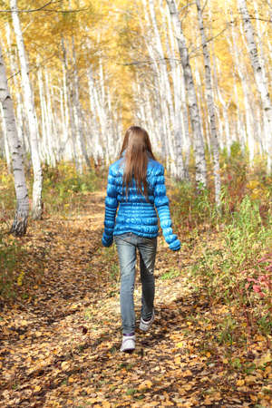 Lonely teenage girl in the autumn forestの写真素材