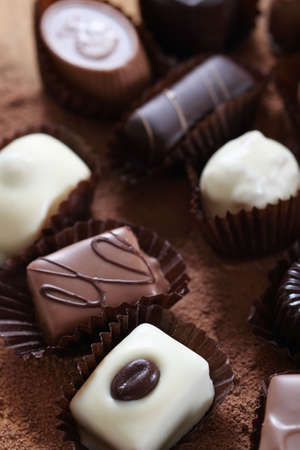 Various types of pralines isolated on  chocolate background