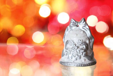 Christmas bell  with silver pattern against blurred backgroundの写真素材