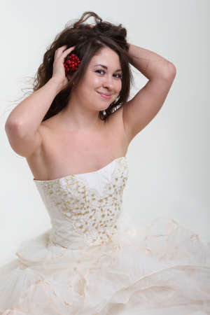 Smiling bride in wedding dress and berries in her hairの写真素材