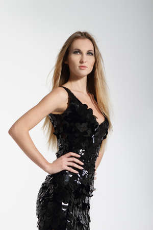 Beautiful blond fashionable girl in black dressの写真素材