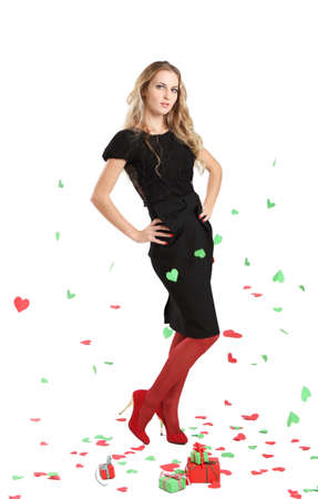 Attractive young woman in evening dress on background with red and green heartsの写真素材