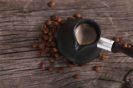 Coffee and coffee beans on the brown woodwn backgroundの写真素材