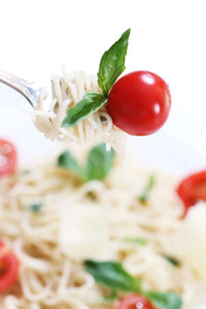 Spaghetti with pesto sauce, cherry tomato and parmesan cheeseの写真素材