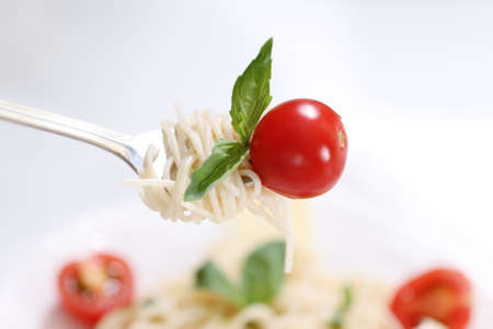 Spaghetti with pesto sauce, cherry tomato and parmesan cheeseの写真素材