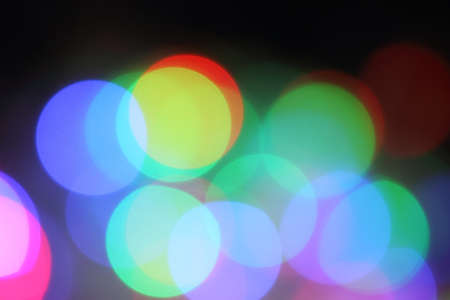 Blurred background with round shaped lights on blackの写真素材