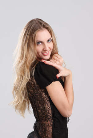 Portrait of the beauty young blond curly girl in black の写真素材