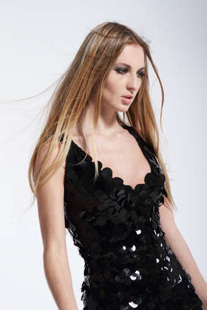 Beautiful blond fashionable girl in black evening dressの写真素材