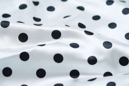 Black polka dots on a white background. Fabricの写真素材