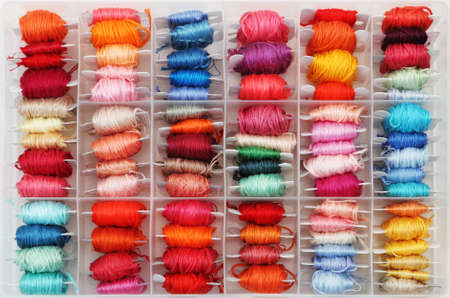 Colorful bobbins in the plastic box. Close upの写真素材