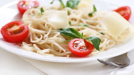 Spaghetti with pesto sauce, cherry tomato and parmesan cheeseの写真素材