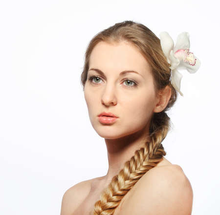Portrait of the beauty young blond girl with orchid in her hairの写真素材