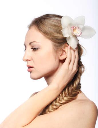 Portrait of the beauty young blond girl with orchid in her hairの写真素材