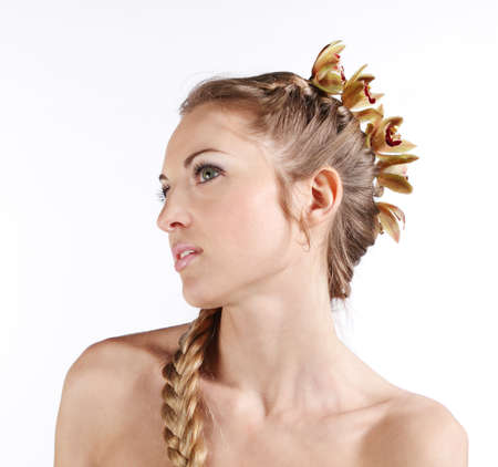 Portrait of the beauty young blond girl with orchid in her hairの写真素材