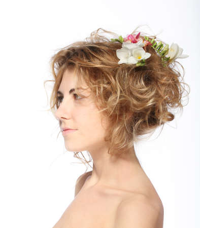 Portrait of the beauty young blond girl with freesia in her hairの写真素材