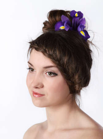 Portrait of the beauty young brunette girl with iris in her hairの写真素材