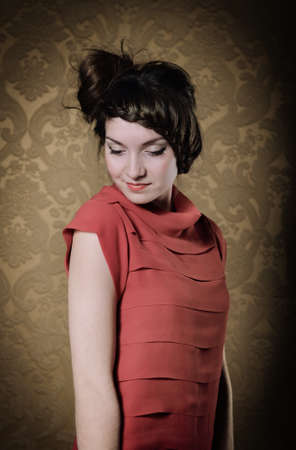 Portrait of the beautiful stylish brunette woman in redの写真素材