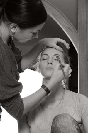 Client and stylist. Stylist working with a model in the backstageの写真素材