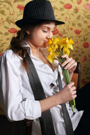 Portrait of the beautiful stylish brunette woman with narcissusesの写真素材