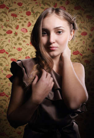 Portrait of the beauty young blond girl near the wall with rosesの写真素材