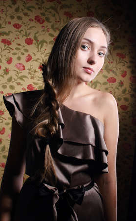 Portrait of the beauty young blond girl near the wall with rosesの写真素材