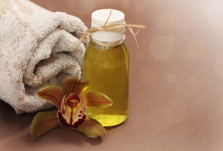 Spa setting with orchid, towel and massage oilの写真素材