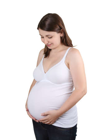 Happy caucasian pregnant woman touching her bellyの写真素材