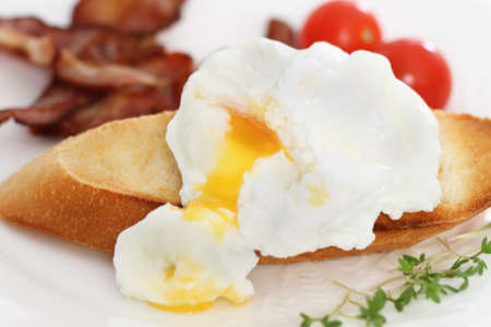 Eggs Benedict on the toast. Breakfast on the plateの写真素材