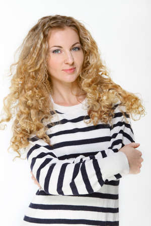Portrait of the beautiful blond girl in striped jumperの写真素材