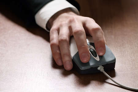 Image of a computer mouse in hand businessmanの写真素材