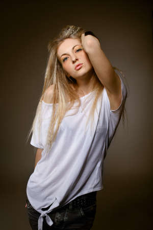 Portrait of young blond girl in a white t-shirt with make upの写真素材