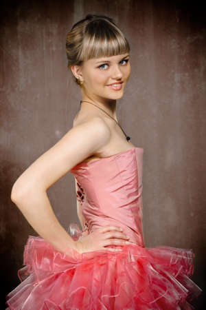 Portrait of the beauty young blond girl near the brown wallの写真素材
