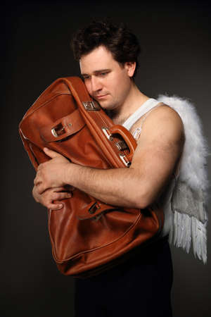 Mr. Angel with brown bag. Creepy character portrait.の写真素材