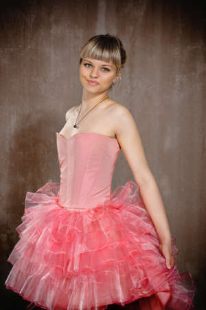 Portrait of the beauty young blond girl near the brown wallの写真素材