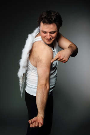 The man with white wings shows on a shoulderの写真素材