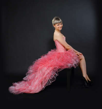 Portrait of the beauty young blond girl in the pink dressの写真素材