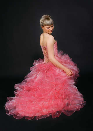 Portrait of the beauty young blond girl in the pink dressの写真素材