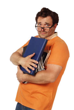 Young man in glasses holding bunch of booksの写真素材