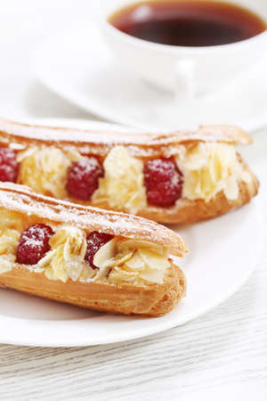 Cake with a raspberry, whipped cream and a peanutの写真素材