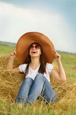 Smiling brunette girl in hat in summer dayの写真素材