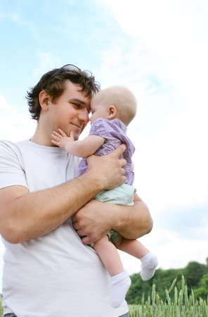 Happy young father with little daughter outdoorsの写真素材