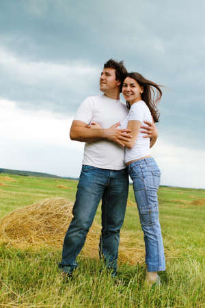 Portrait of a young couple in love outdoors in fieldの写真素材
