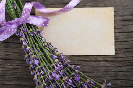 Fresh lavender decorated with ribbon over wooden backgroundの写真素材
