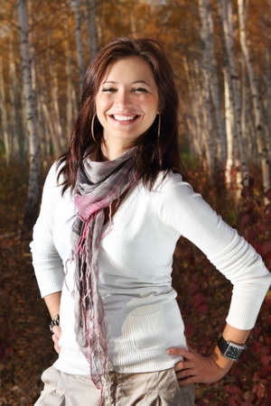 Young attractive smiling girl in autumn parkの写真素材