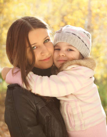 Portrait of two smiling sisters in autumn forestの写真素材