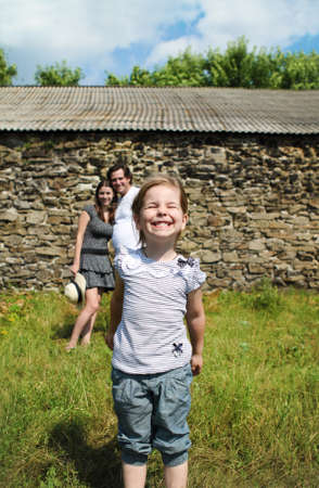 Happy yong family with daughter outdoorsの写真素材
