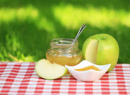 Jar of apple jam on the table in the summer gardenの写真素材